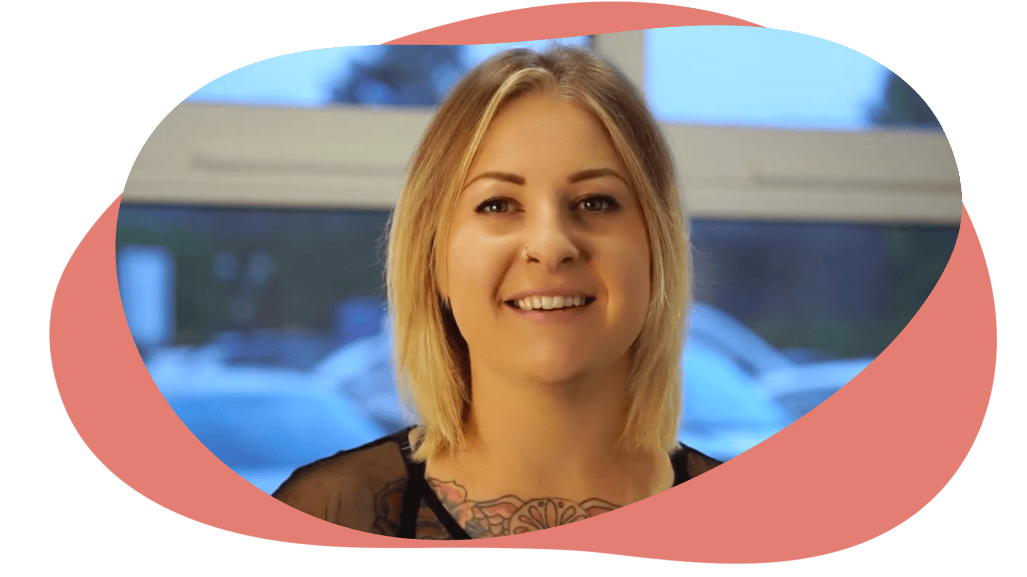 Jess smiling against a blue background