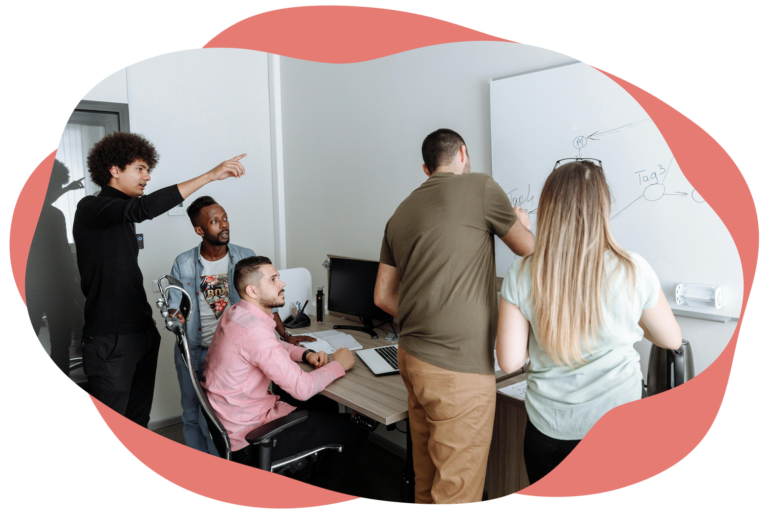 Team collaborating around a whiteboard in an office Team collaborating around a whiteboard in an office