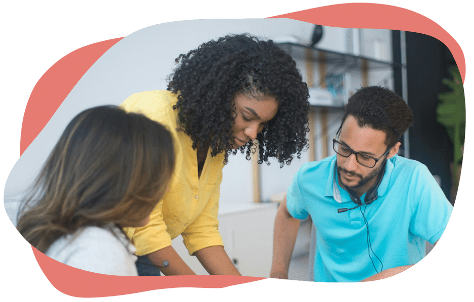 Three people working together at a desk