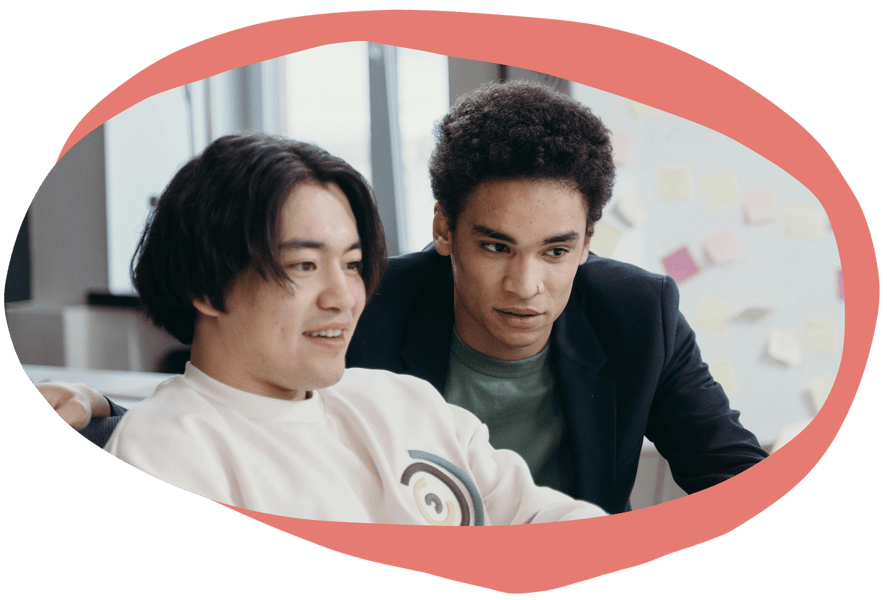 Two people looking at a laptop