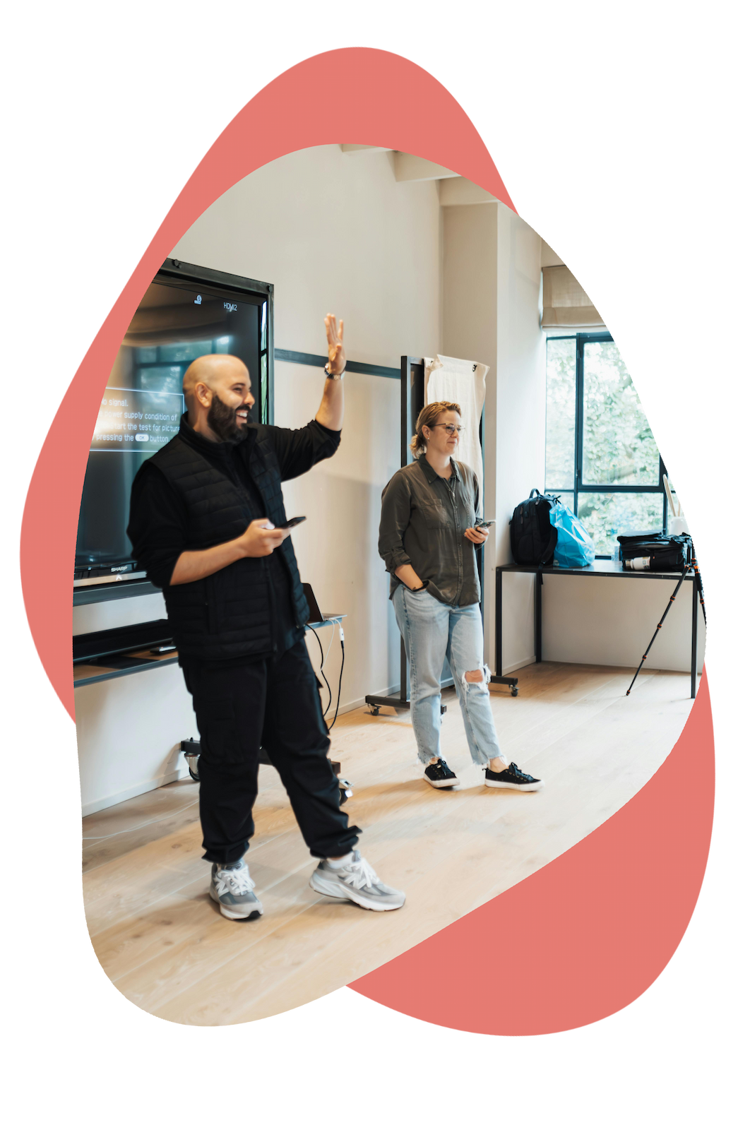 Two people presenting at the front of a training room