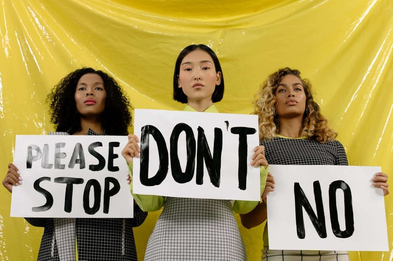 Women holding signs please stop no (1)