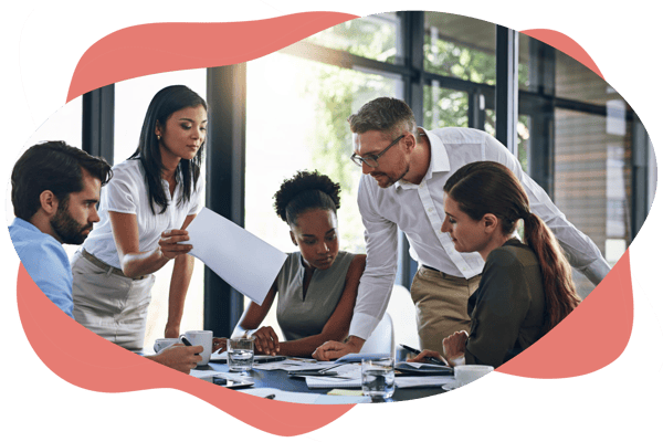 A group of people gathered around a table in a meeting, reviewing documents and discussing work together. A group of people gathered around a table in a meeting, reviewing documents and discussing work together.
