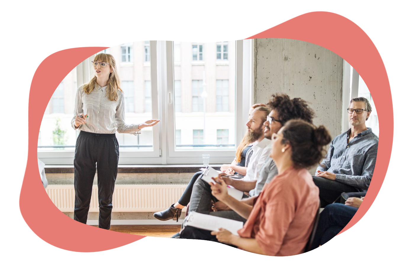 A group of people in a training session with someone presenting