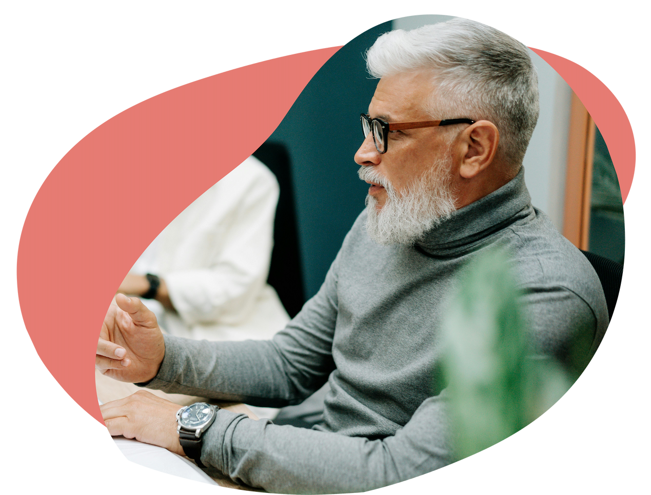 A person sat at a shared work table taking notes A person sat at a shared work table taking notes