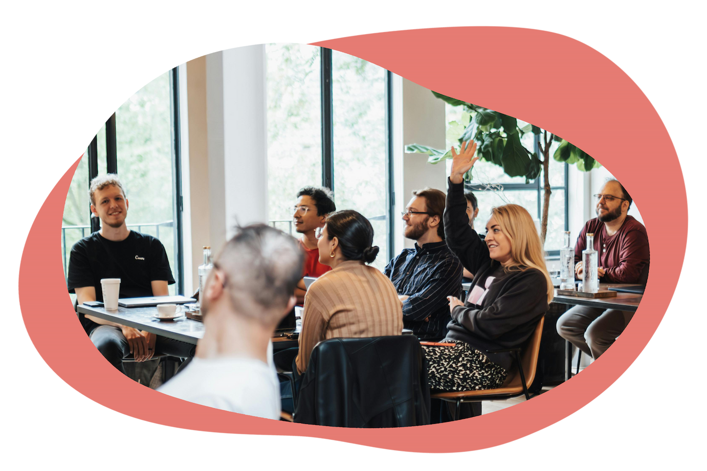 Group discussion with participants raising hands in a workshop setting